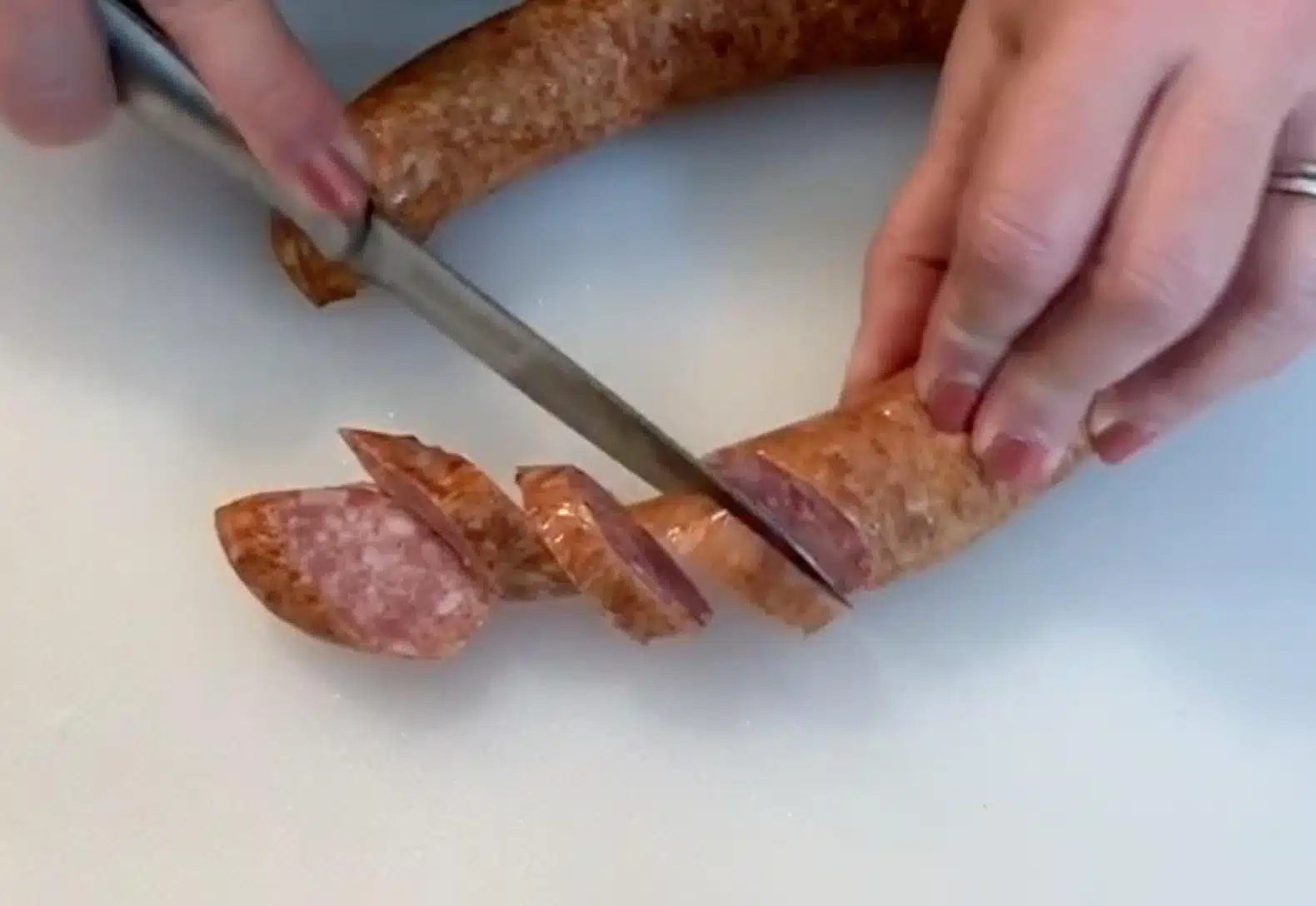 Slicing Smoked Sausage Slicing Smoked Sausage on cutting board