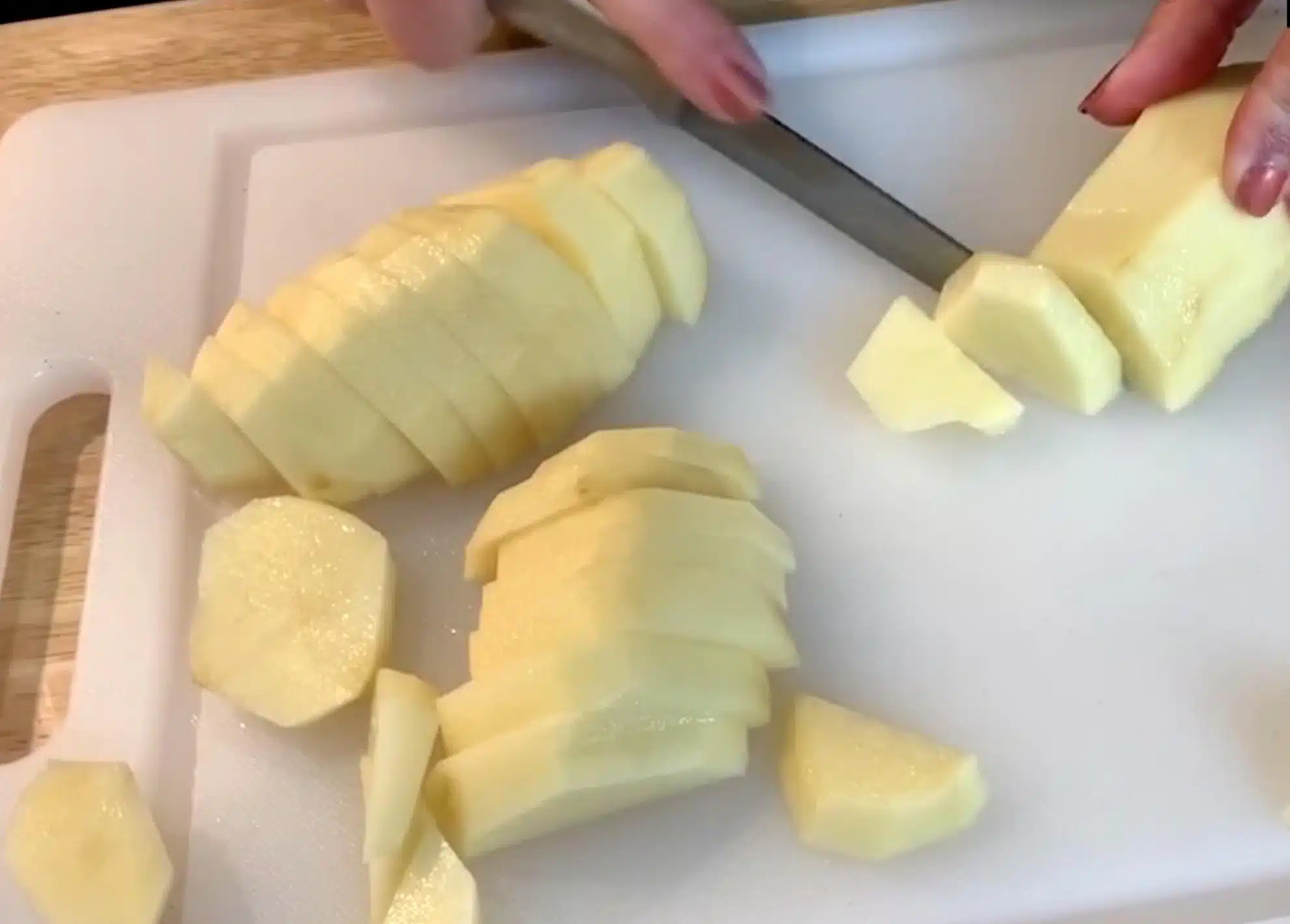 Slicing Potatoes Slicing Potatoes on cutting board