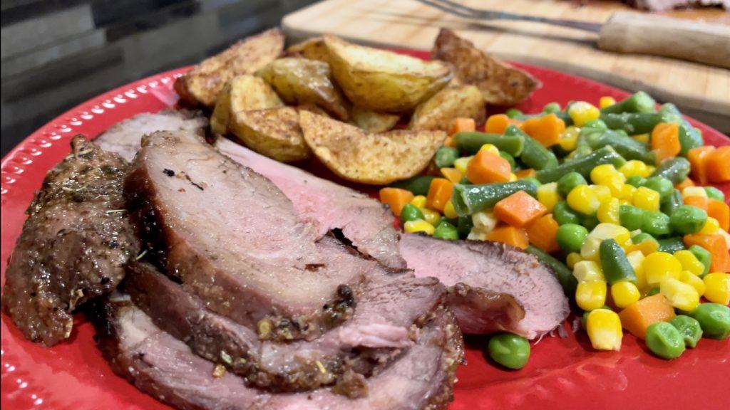 Grilled Sirloin Tip Roast on red plate