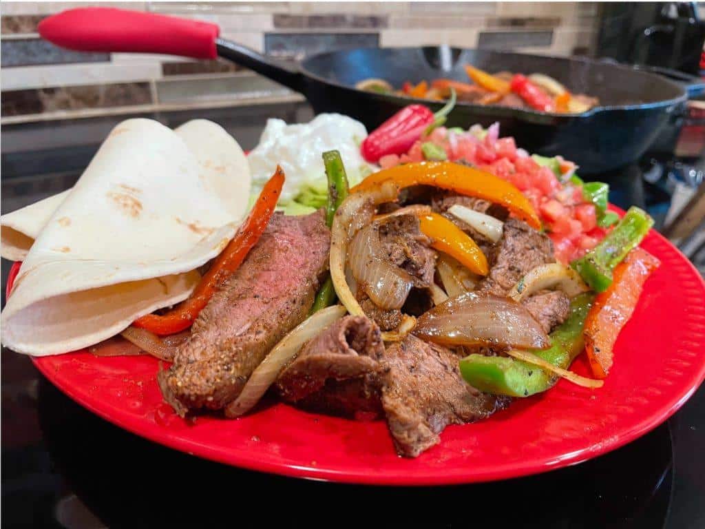 Flat Iron Steak Fajitas on red plate