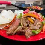 Flat Iron Steak Fajitas on red plate
