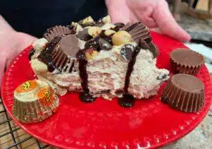 No Bake Peanut Butter Pie drizzled in chocolate and Reese Peanut Butter Cups