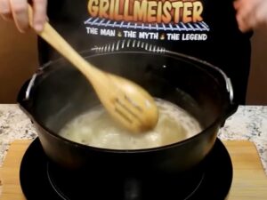 a person stirring liquid in a pot for pickling