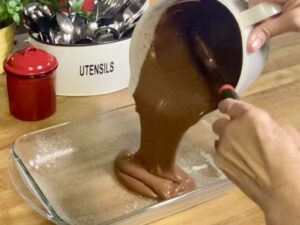 pouring cake mix into baking dish