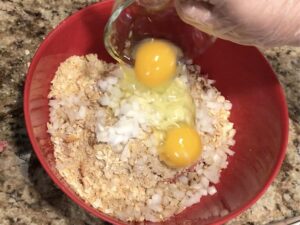 Mixing the beef for Mac and Cheese Meatloaf Casserole